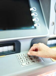 person typing at atm