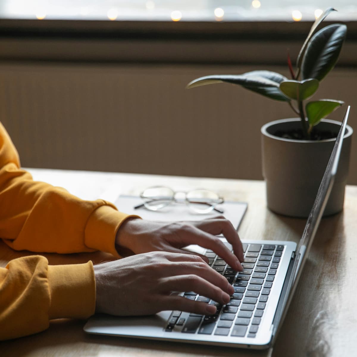 Person typing an email on a laptop to contact support services