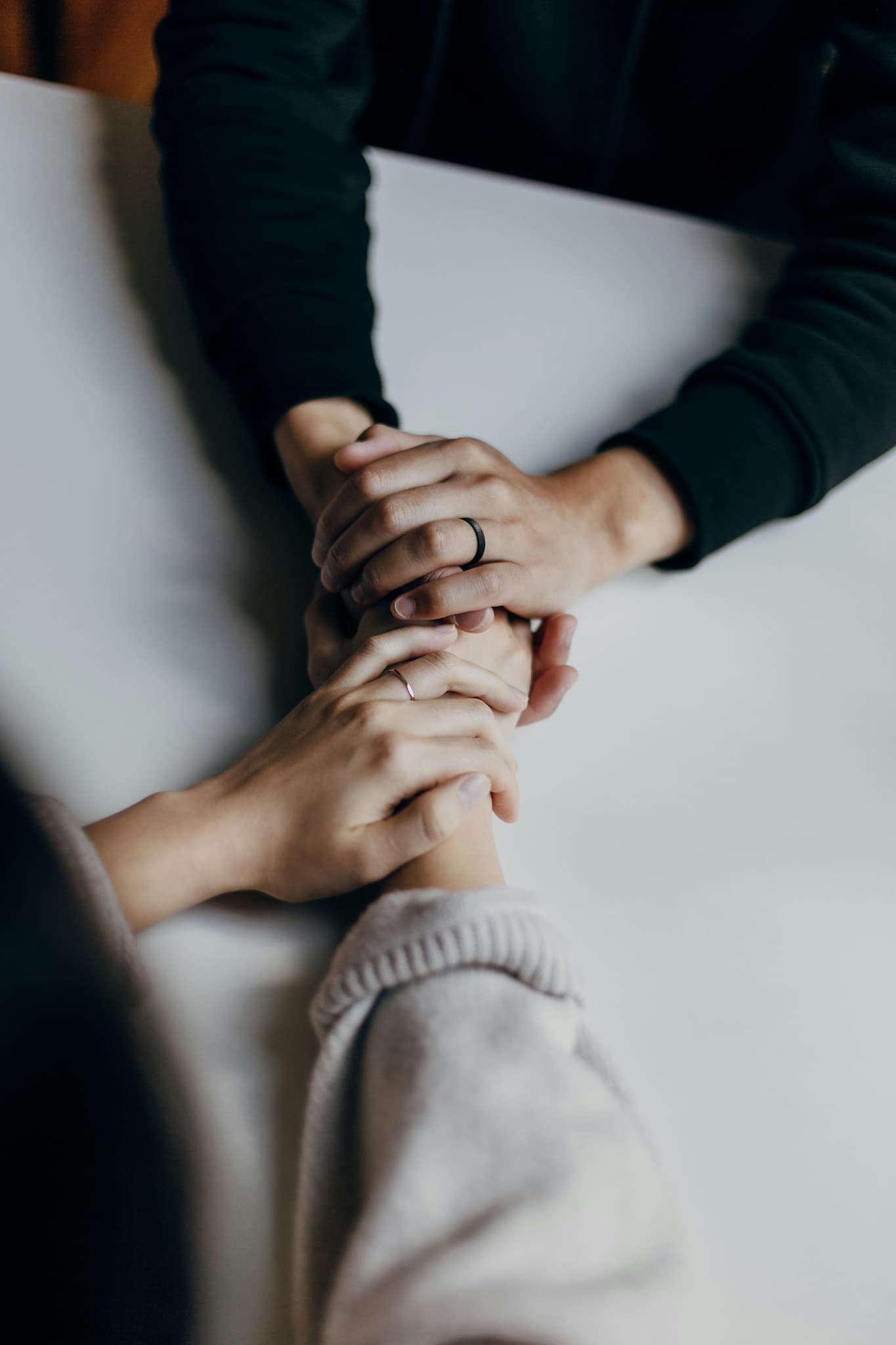 People holding hands representing collaboration between support services for residents